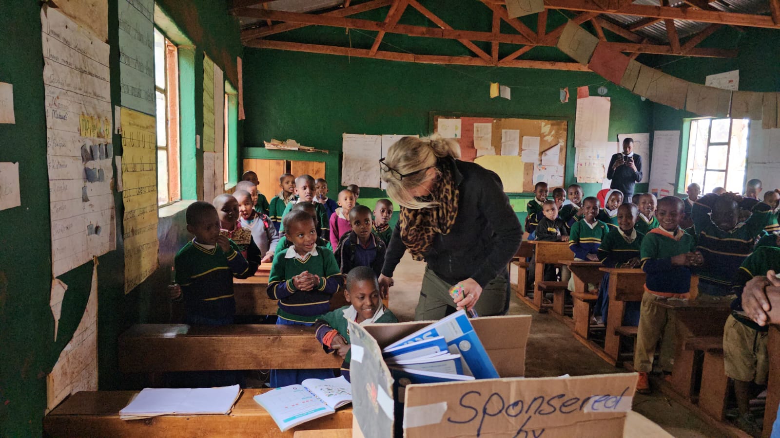 Doris distributing school supplies to children at Kiserian school